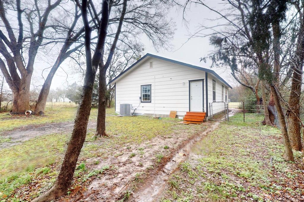 505 Oak Street Commerce, TX 75428 - Photo 27 of 28 a view of a house with a yard and trees