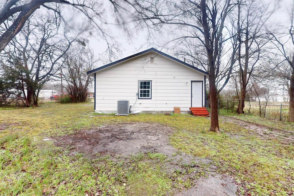 505 Oak Street Commerce, TX 75428 - Photo 28 of 28 a view of a house with a yard and large tree