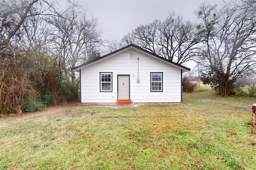 505 Oak Street Commerce, TX 75428 - Photo 8 of 28 a view of a house with a yard covered in snow