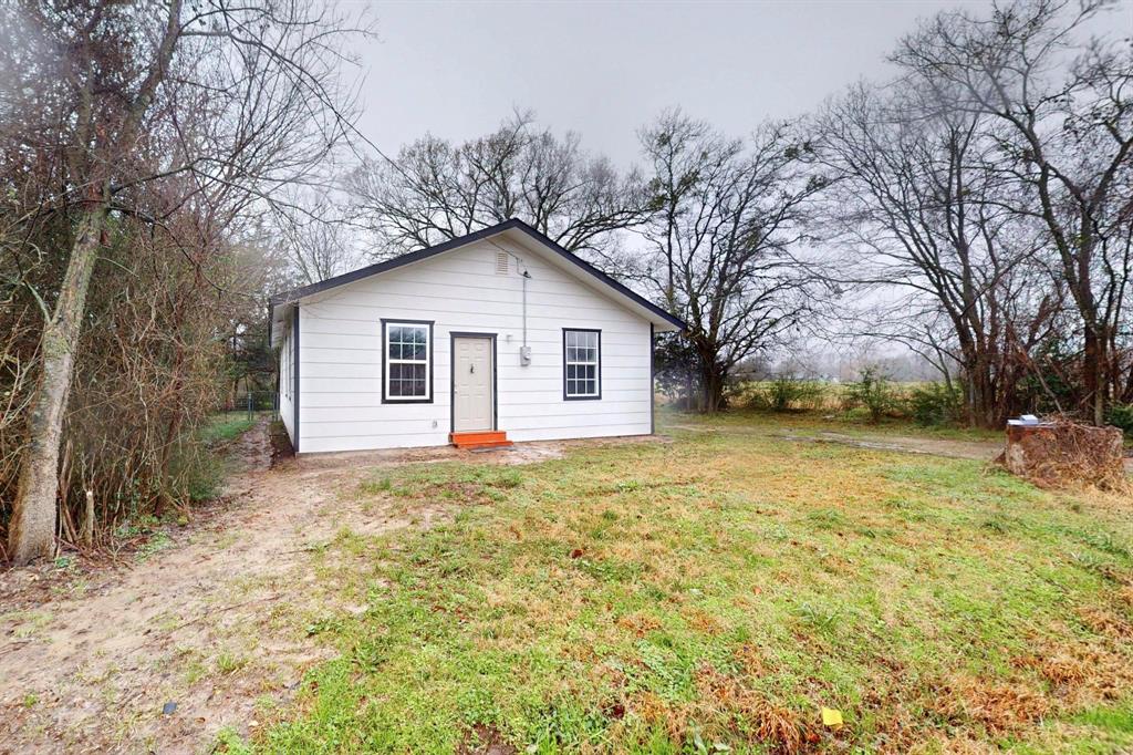 505 Oak Street Commerce, TX 75428 - Photo 9 of 28 a view of a yard in front of a house with large trees