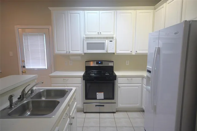 a kitchen with a sink and a refrigerator