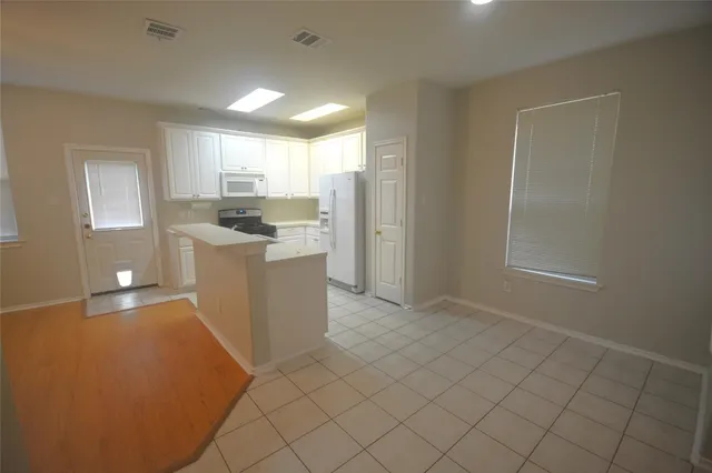 a kitchen with a sink cabinets and a window