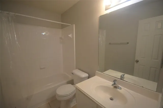 a view of hallway with a bathroom