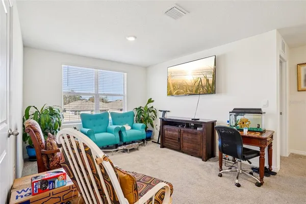 a living room with furniture and a floor to ceiling window