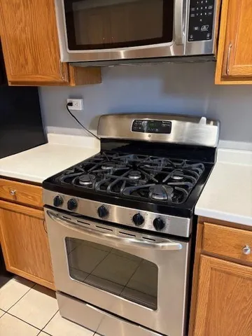a stove top oven sitting inside of a kitchen