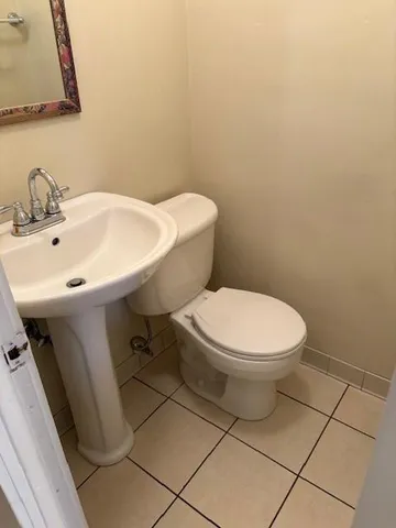 a white toilet sitting next to a white sink