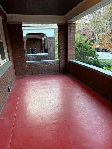 a view of empty room with fireplace and window