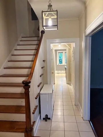 a view of entryway and hall with wooden floor