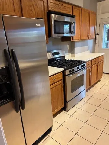 a kitchen with granite countertop cabinets and steel stainless steel appliances