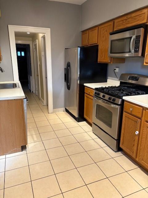 5648 Melvin Street Pittsburgh, PA 15217 - Photo 10 of 22 a kitchen with stainless steel appliances granite countertop a stove a refrigerator and a cabinets