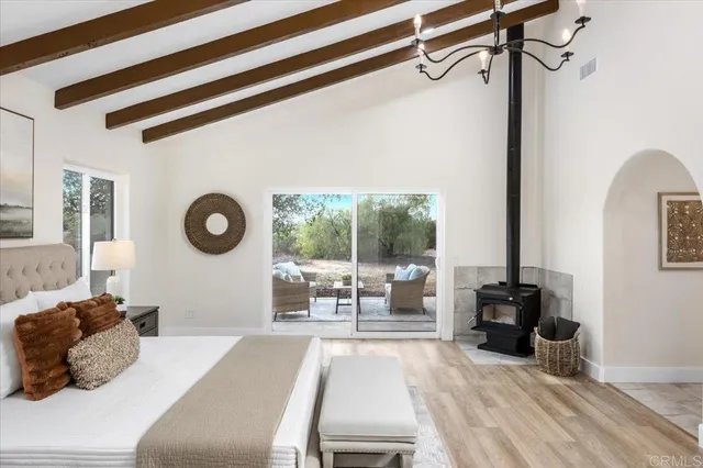 a bedroom with furniture and a mirror