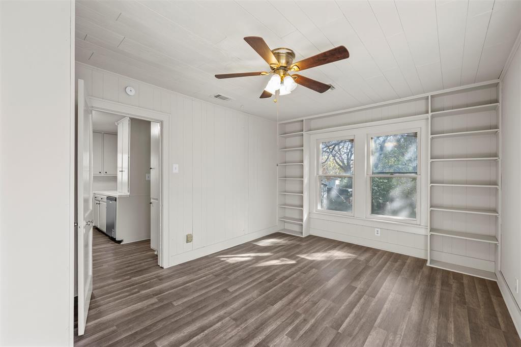 2912 Edmond Avenue Waco, TX 76707 - Photo 14 of 30 Unfurnished room featuring built in features, dark wood-type flooring, and ceiling fan