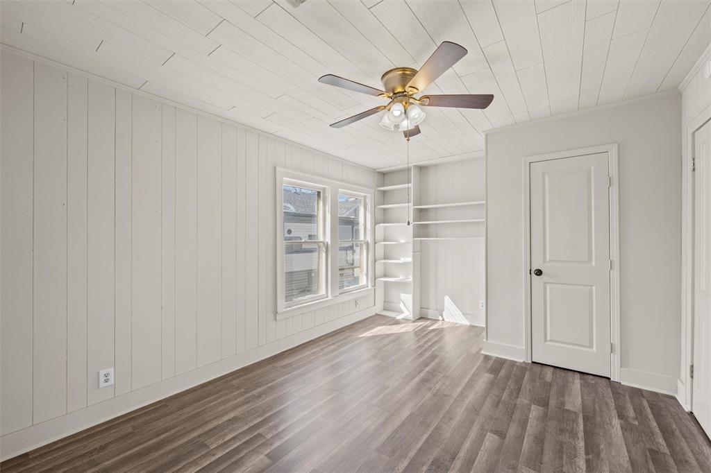 2912 Edmond Avenue Waco, TX 76707 - Photo 15 of 30 Unfurnished room with dark wood finished floors, built in shelves, ceiling fan, and wooden ceiling
