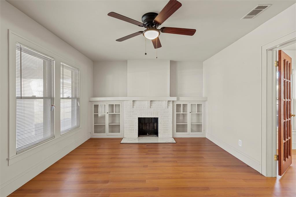 2912 Edmond Avenue Waco, TX 76707 - Photo 23 of 30 Unfurnished living room with light wood-type flooring, a fireplace, and ceiling fan
