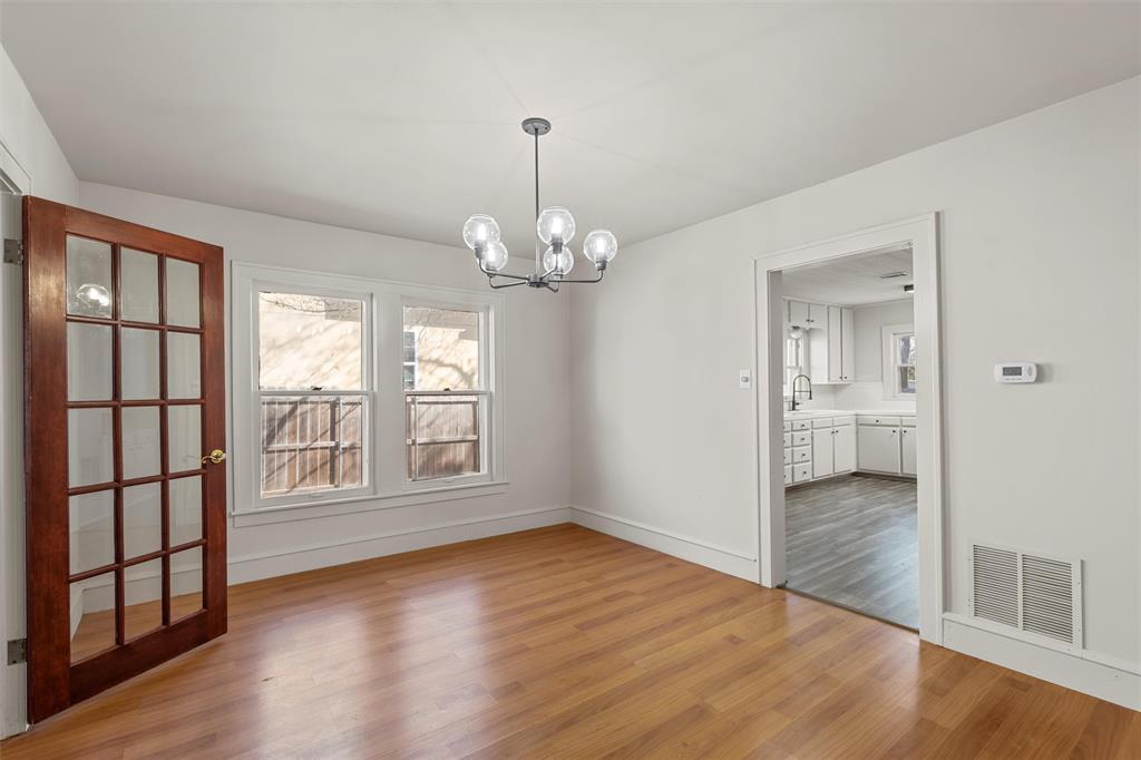 2912 Edmond Avenue Waco, TX 76707 - Photo 5 of 30 Unfurnished dining area featuring a chandelier and light wood-type flooring