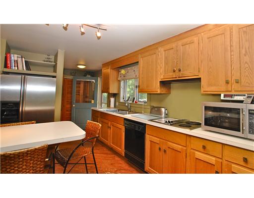162 Franklin Road Scituate, RI 02825 - Photo 4 of 20 Kitchen. The heart of this home, central to all activity, it features a breakfast bar and a full laundry area...convenience and function were in the design and a part of the daily activity