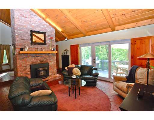 162 Franklin Road Scituate, RI 02825 - Photo 7 of 20 Living Room. The highlight of this room is the comfortable layout and accessability to the home. Central fireplace is equipped with a pellet stove which warms the space with amazing, even heat. Up the wide and welcoming wide staircase to the upper loft.