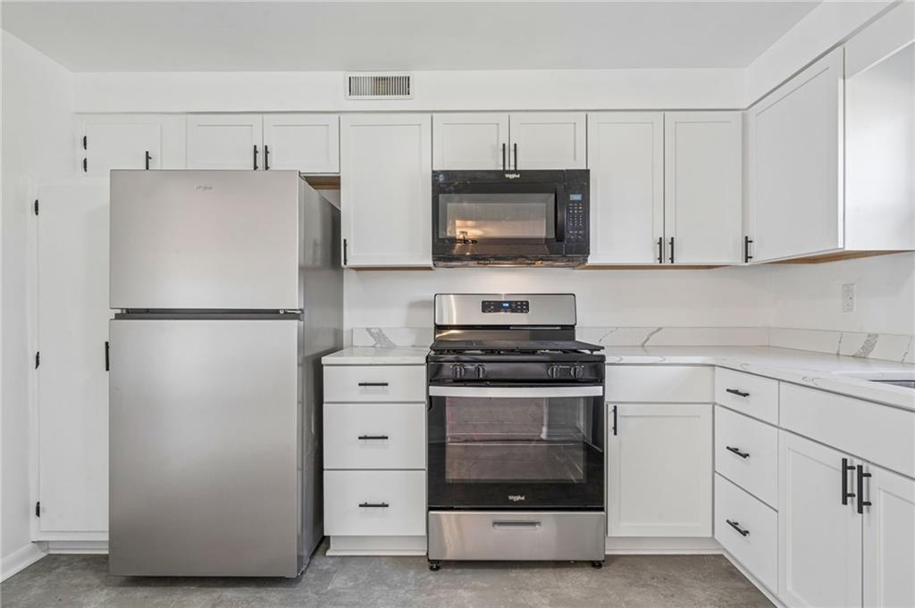 773 Homestead Avenue Scottdale, PA 15683 - Photo 12 of 28 a kitchen with white cabinets and stainless steel appliances