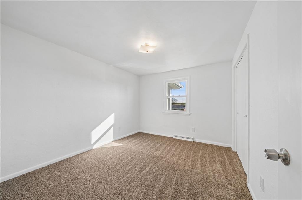 773 Homestead Avenue Scottdale, PA 15683 - Photo 17 of 28 an empty room with wooden floor and windows