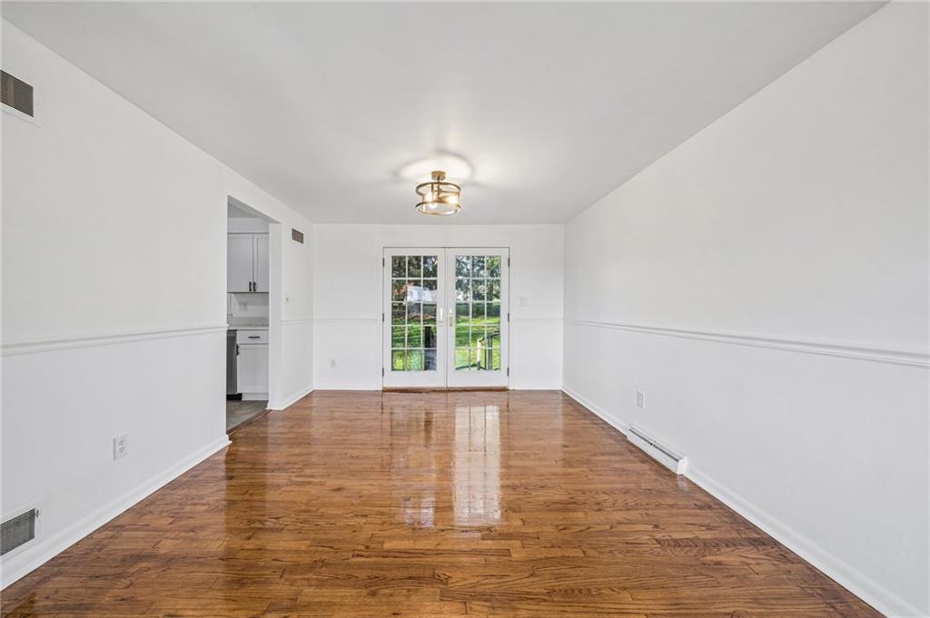 773 Homestead Avenue Scottdale, PA 15683 - Photo 6 of 28 a view of an empty room with wooden floor and a window