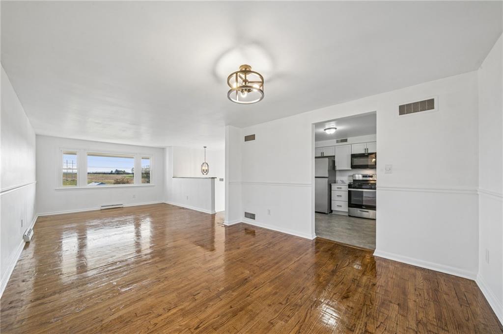 773 Homestead Avenue Scottdale, PA 15683 - Photo 7 of 28 a view of empty room with wooden floor