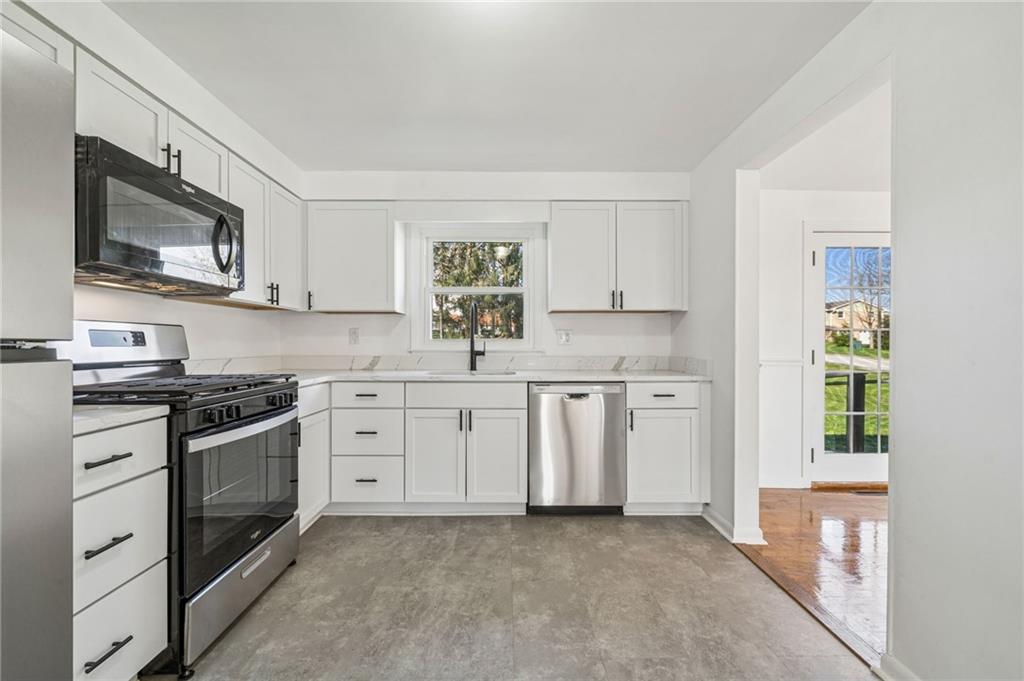 773 Homestead Avenue Scottdale, PA 15683 - Photo 10 of 28 a kitchen with white cabinets stainless steel appliances and a window