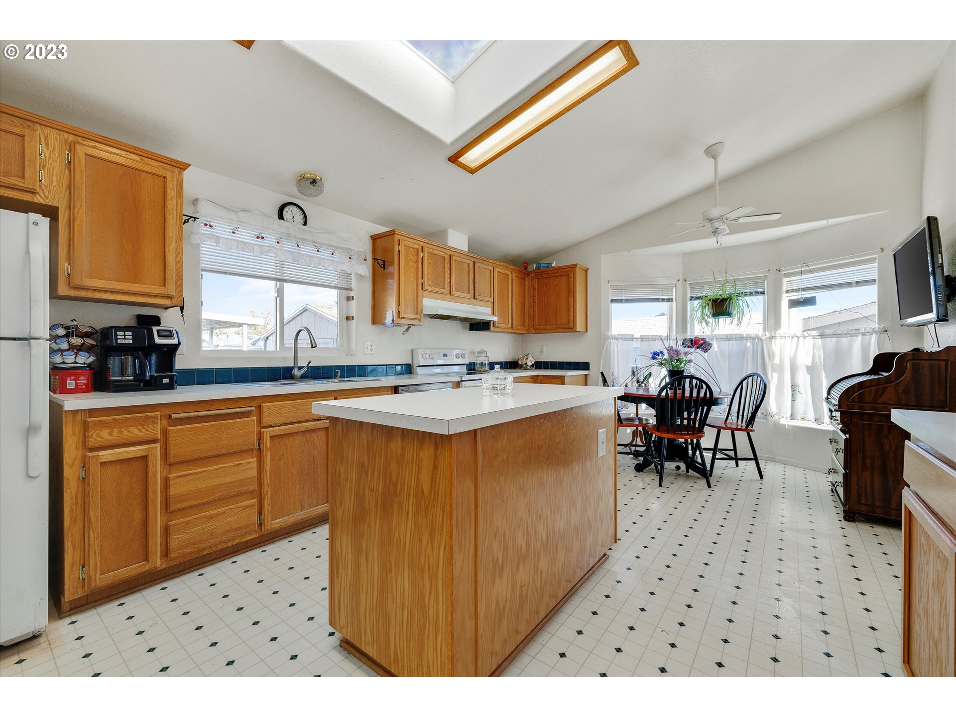 20804 Butteville Road Northeast Donald, OR 97020 - Photo 6 of 18 a kitchen with stainless steel appliances kitchen island granite countertop a sink counter space and a window