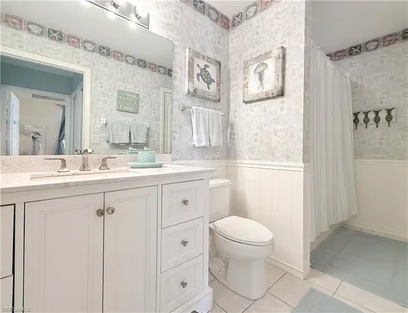 a bathroom with a sink a toilet a shower and a mirror