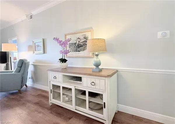 a view of a workspace with furniture and wooden floor