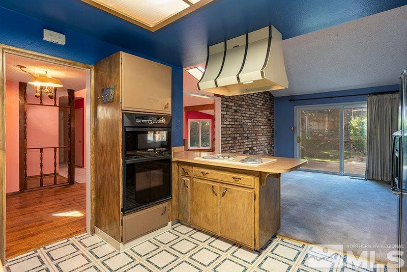 1401 Peavine Road Reno, NV 89503 - Photo 8 of 17 a kitchen with stainless steel appliances granite countertop a stove a sink and a refrigerator