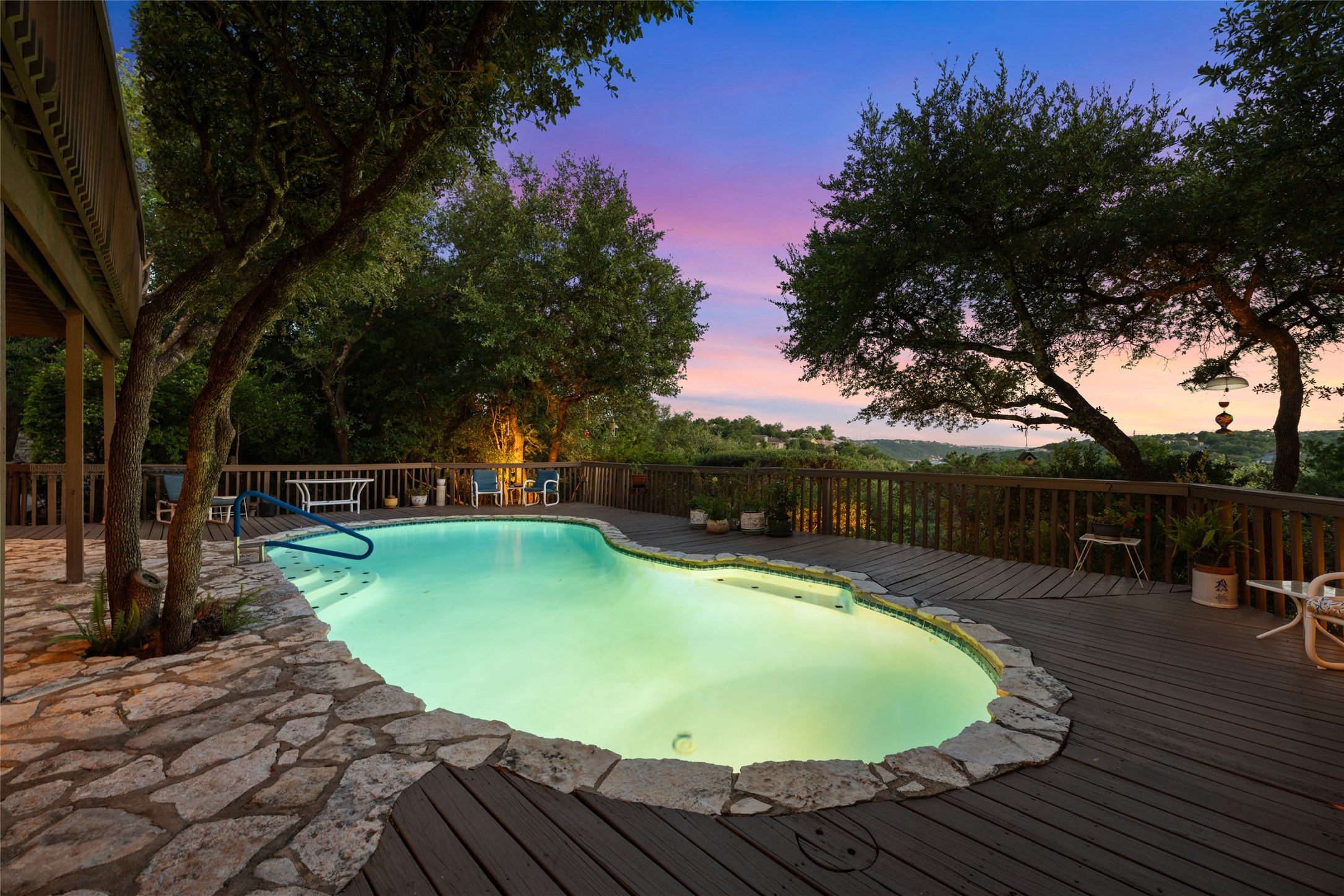 5319 Musket Ridge Austin, TX 78759 - Photo 37 of 39 An inviting pool, seamlessly integrated into a spacious wooden deck, awaits with serene evening views.