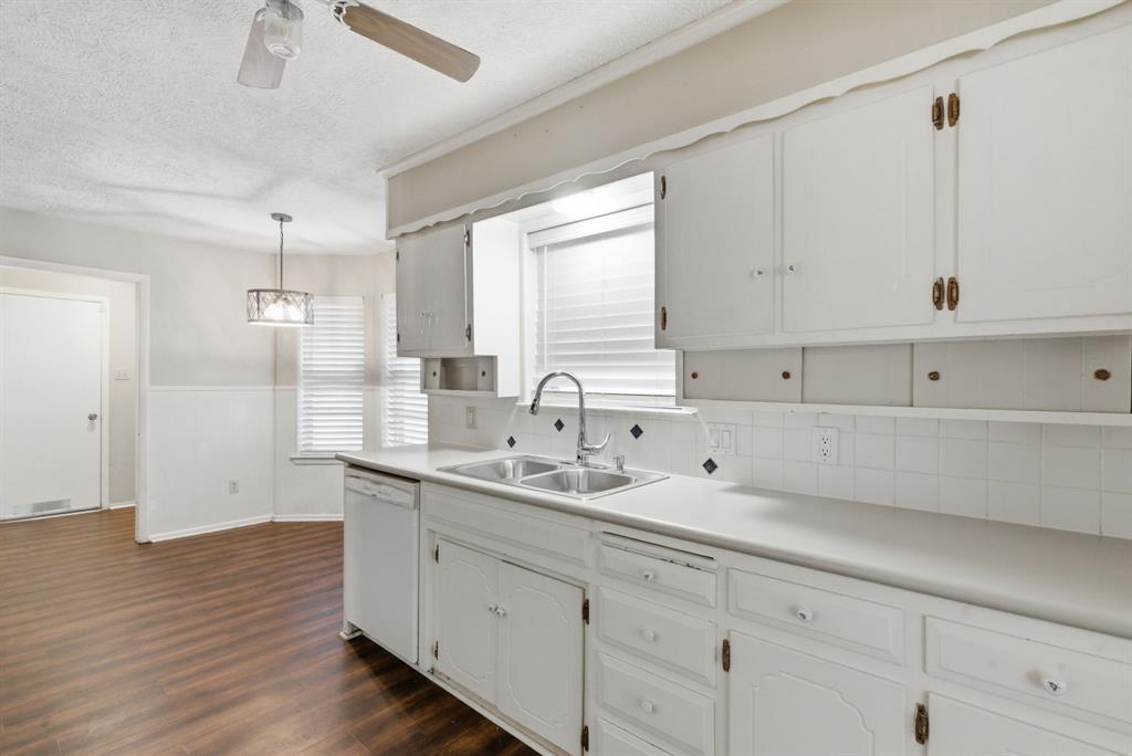 120 Timberlake Drive Azle, TX 76020 - Photo 11 of 32 a view of a sink and cabinets with wooden floor