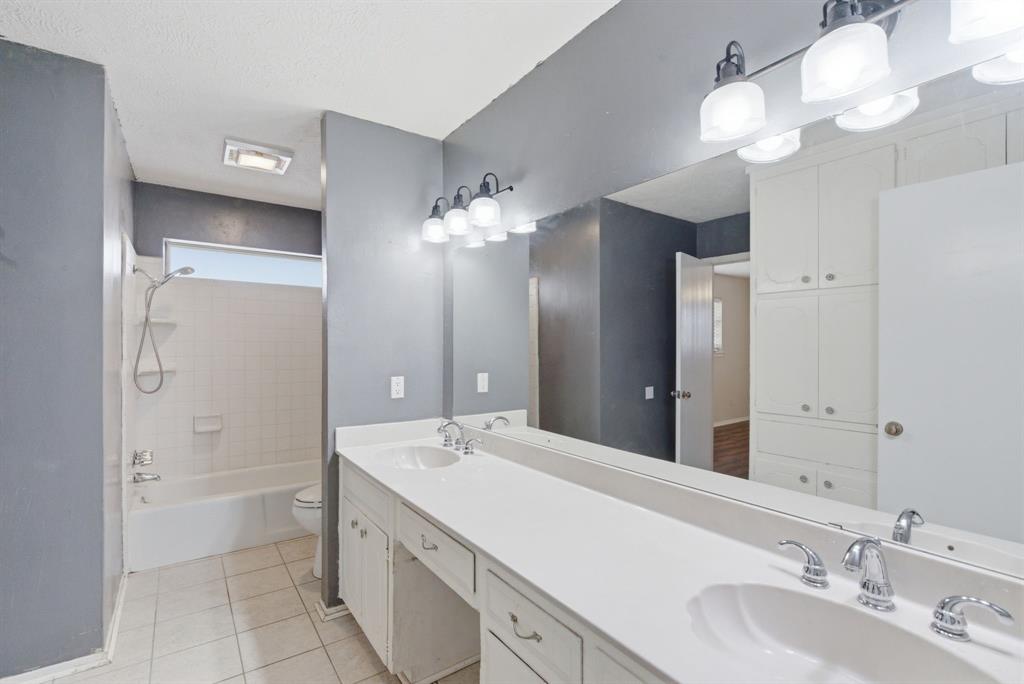 120 Timberlake Drive Azle, TX 76020 - Photo 19 of 32 a bathroom with a double vanity sink and a mirror