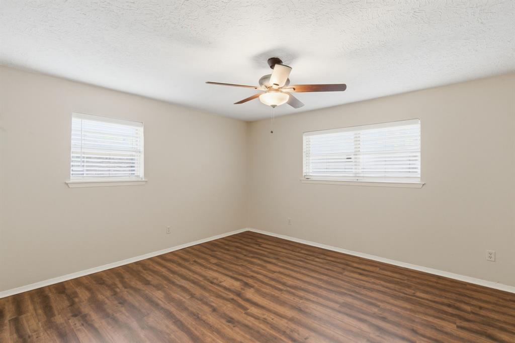 120 Timberlake Drive Azle, TX 76020 - Photo 21 of 32 a view of empty room with wooden floor and fan