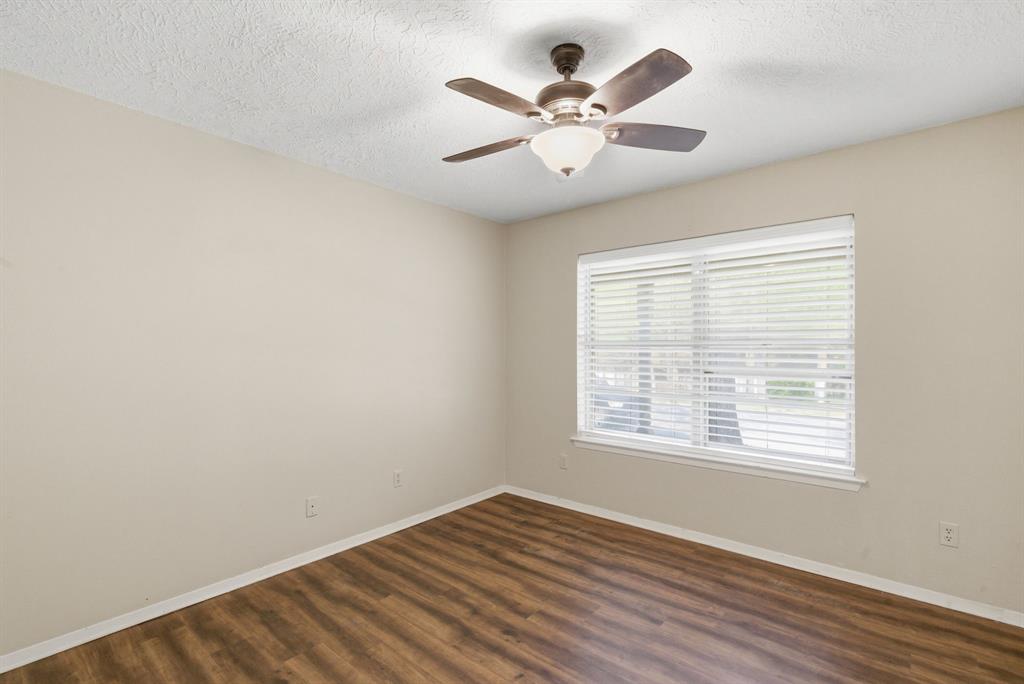 120 Timberlake Drive Azle, TX 76020 - Photo 23 of 32 a view of an empty room with wooden floor and a window
