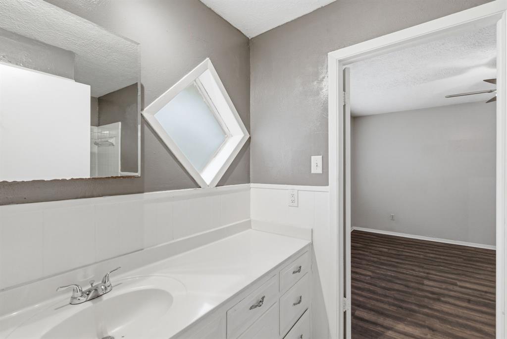 120 Timberlake Drive Azle, TX 76020 - Photo 26 of 32 a bathroom with a sink and a mirror