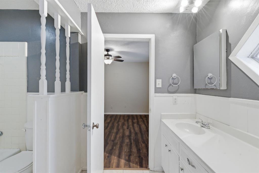 120 Timberlake Drive Azle, TX 76020 - Photo 27 of 32 a bathroom with a sink and a mirror
