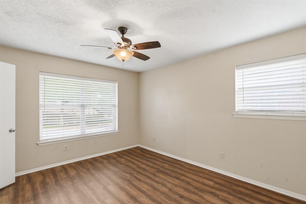 120 Timberlake Drive Azle, TX 76020 - Photo 30 of 32 a view of an empty room with wooden floor and a window
