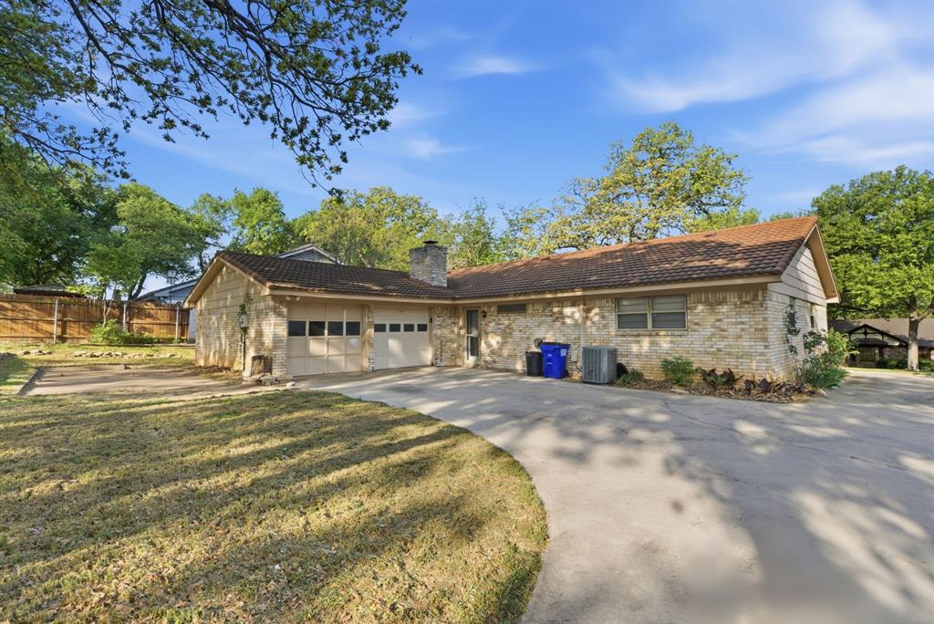 120 Timberlake Drive Azle, TX 76020 - Photo 4 of 32 a front view of a house with a yard and outdoor seating