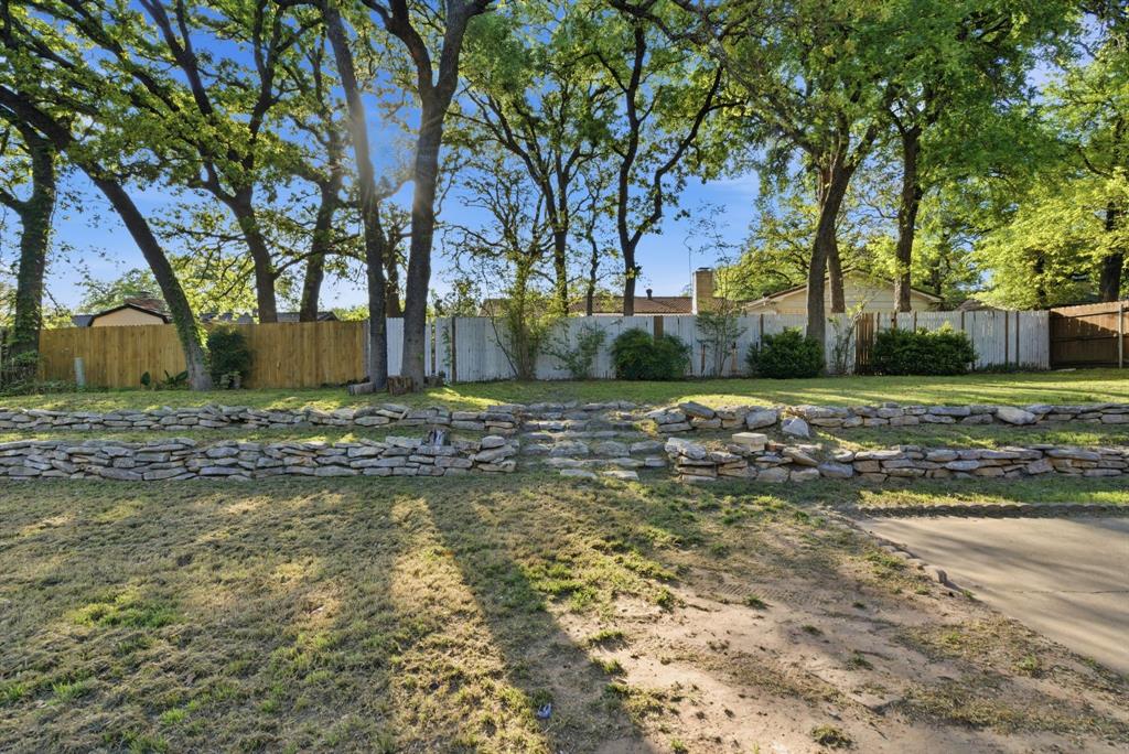 120 Timberlake Drive Azle, TX 76020 - Photo 5 of 32 a view of a yard with a tree