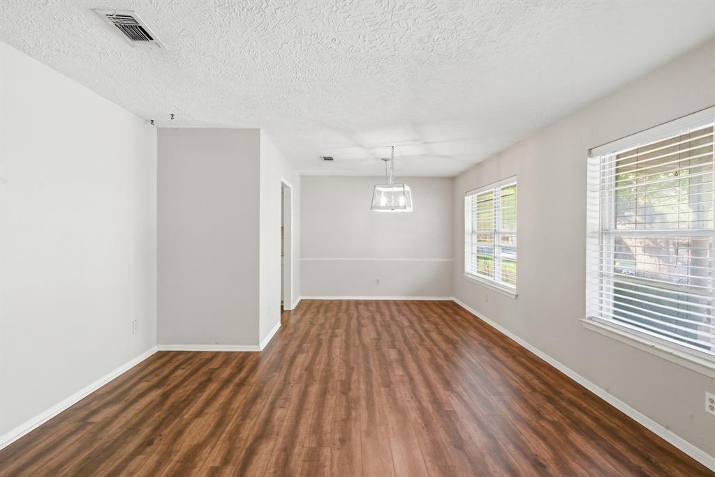 120 Timberlake Drive Azle, TX 76020 - Photo 8 of 32 an empty room with wooden floor and windows
