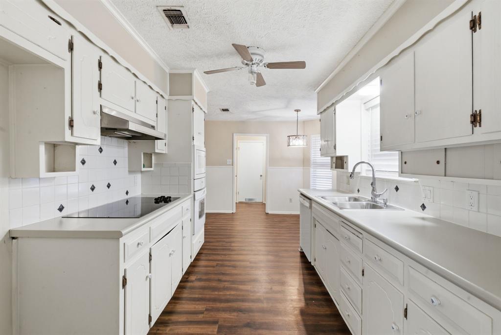 120 Timberlake Drive Azle, TX 76020 - Photo 10 of 32 a large white kitchen with a double vanity sink and stainless steel appliances
