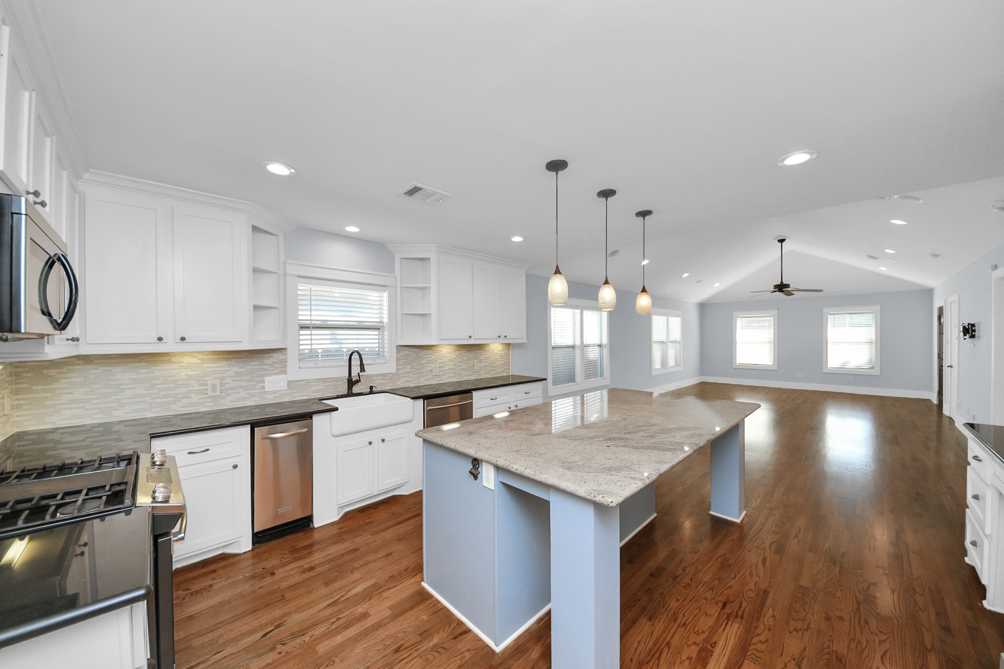 509 Vincent Street Houston, TX 77009 - Photo 14 of 39 a open kitchen with a center island wooden floor and a counter top space