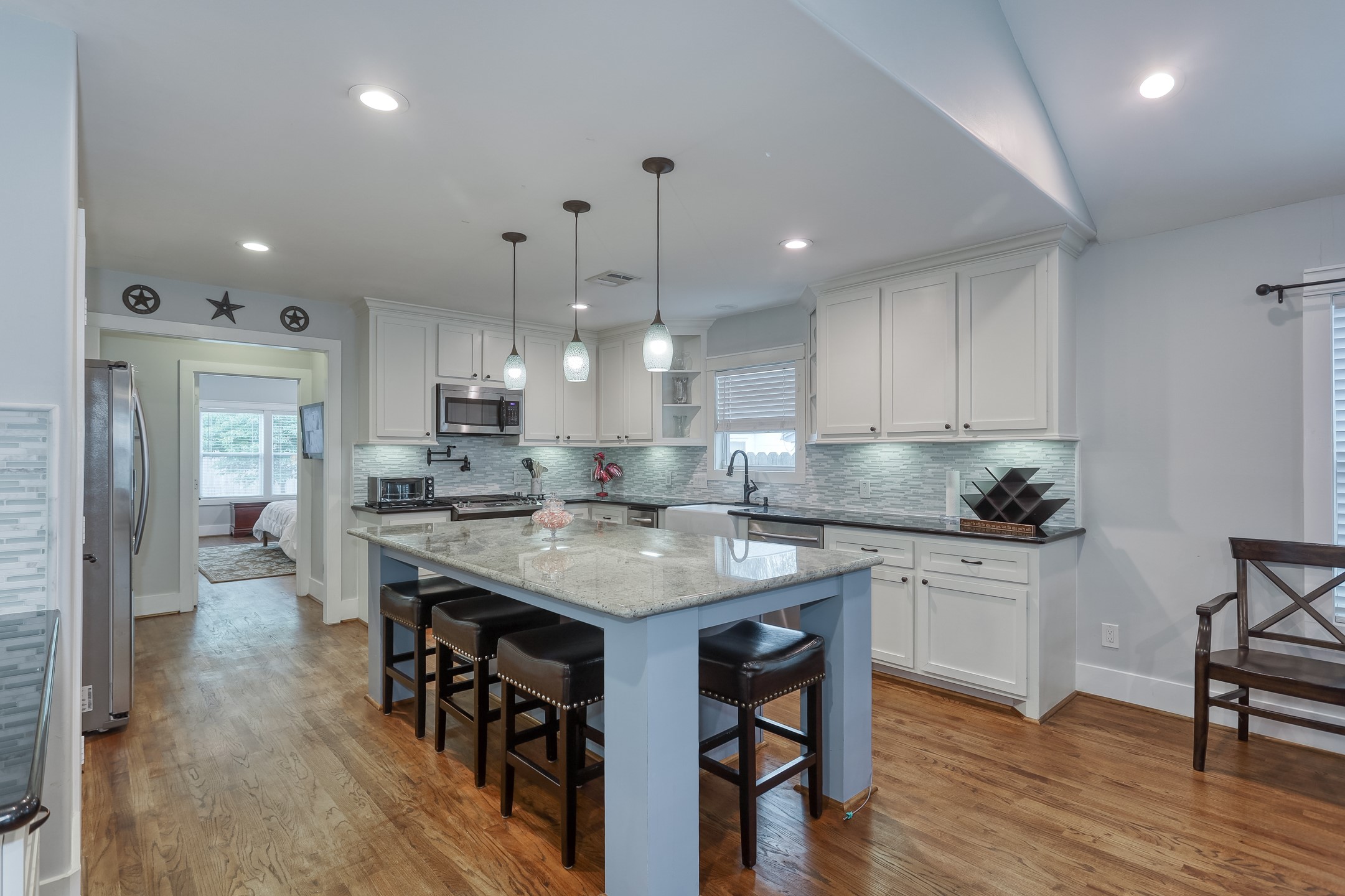 509 Vincent Street Houston, TX 77009 - Photo 15 of 39 a kitchen with stainless steel appliances granite countertop a table chairs sink refrigerator and cabinets