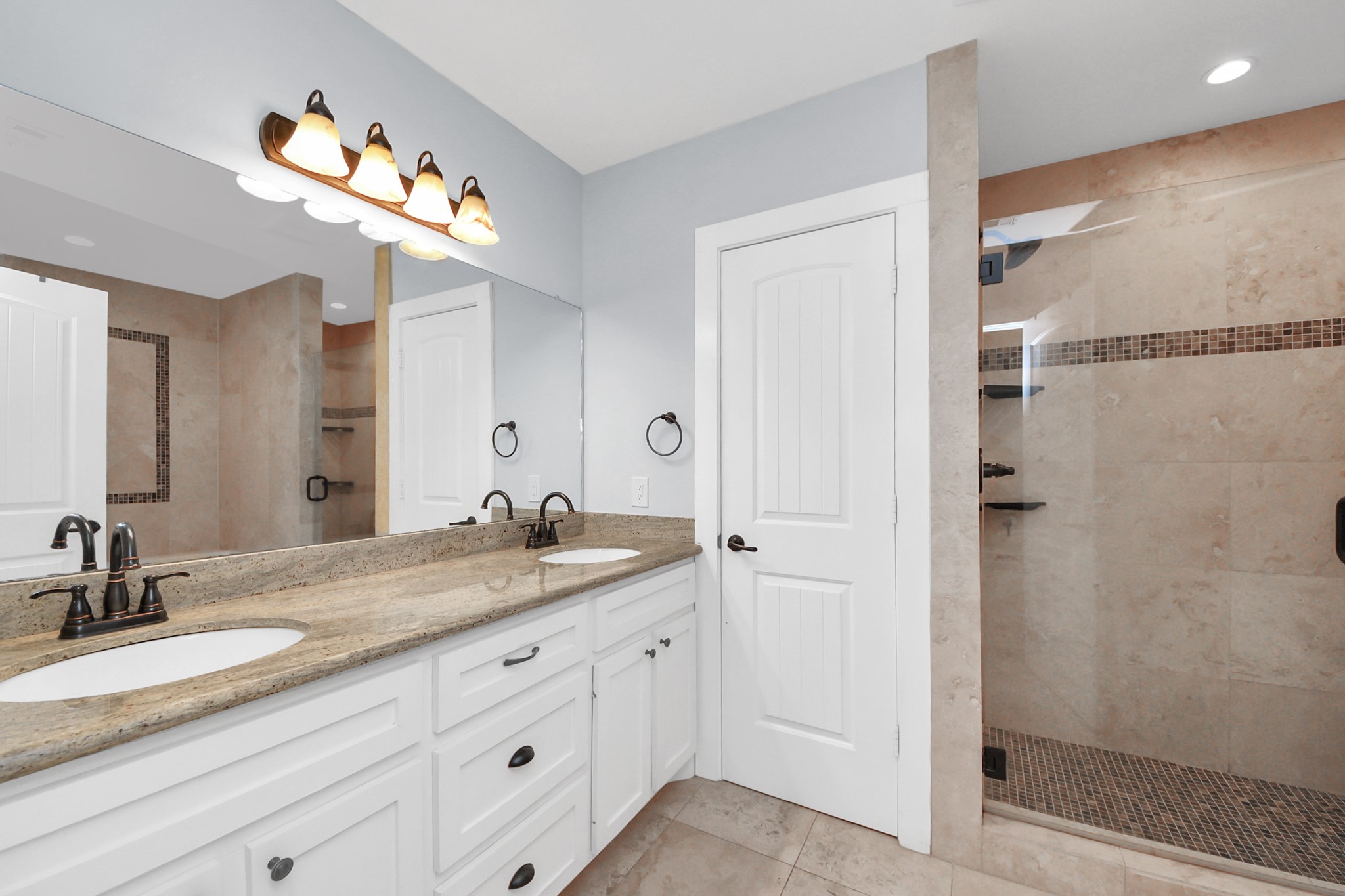 509 Vincent Street Houston, TX 77009 - Photo 23 of 39 a bathroom with a granite countertop sink a mirror and shower