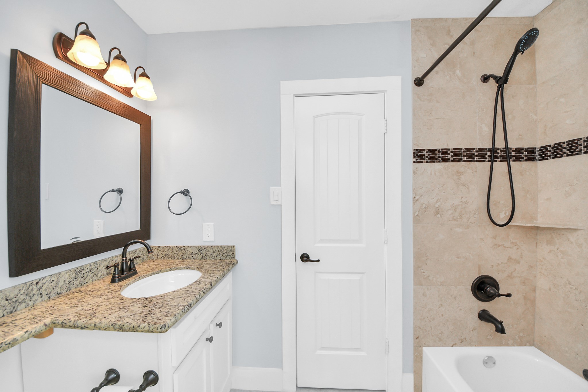 509 Vincent Street Houston, TX 77009 - Photo 29 of 39 a bathroom with a granite countertop sink and a mirror