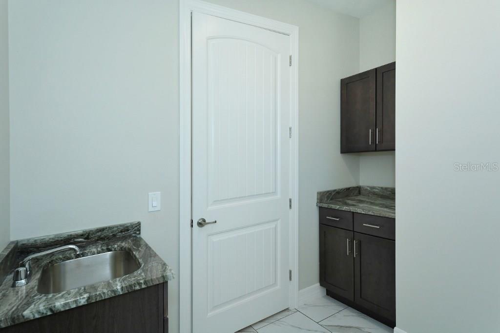 1033 Horizon Road Venice, FL 34293 - Photo 18 of 25 Quartzite counters and solid wood cabinets continue into the laundry room!