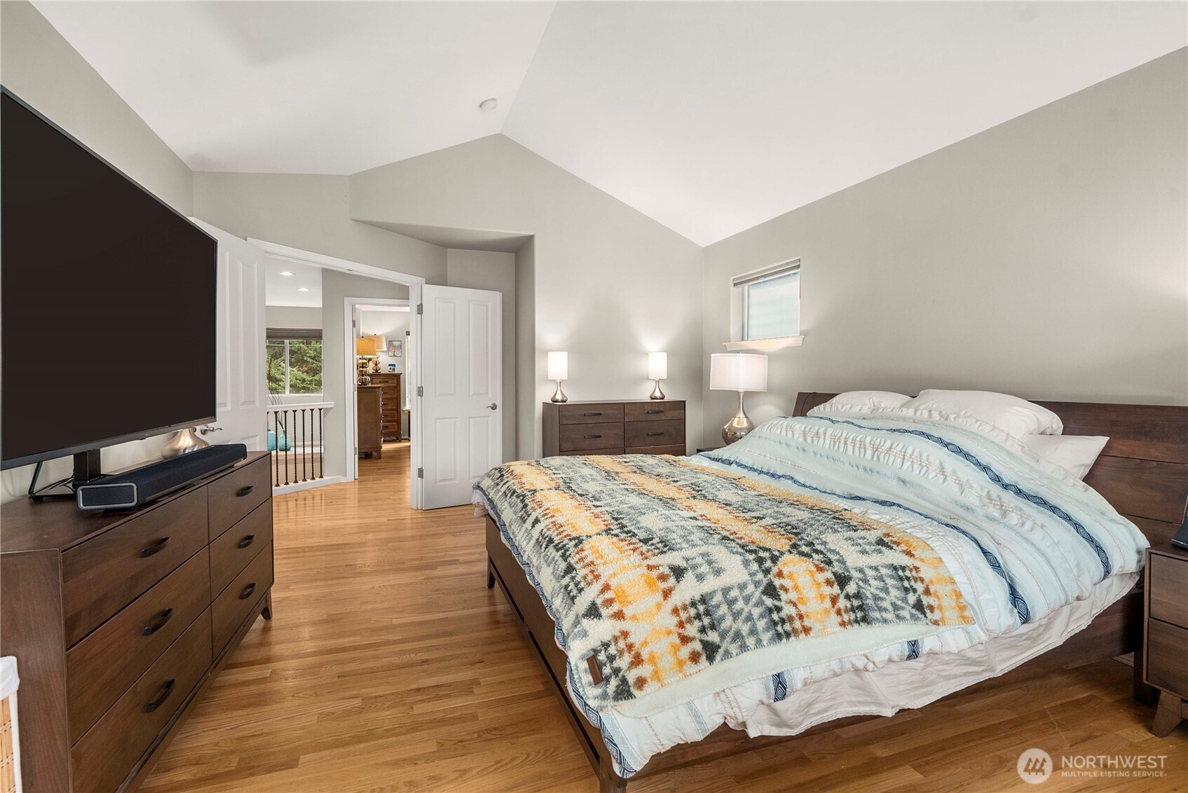 3723 Lincoln Court Northeast Renton, WA 98056 - Photo 19 of 37 a spacious bedroom with a bed and a flat screen tv