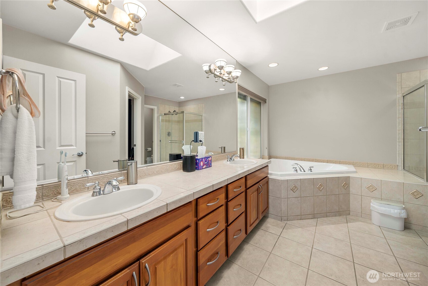 3723 Lincoln Court Northeast Renton, WA 98056 - Photo 22 of 37 a spacious bathroom with a granite countertop sink mirror and bathtub