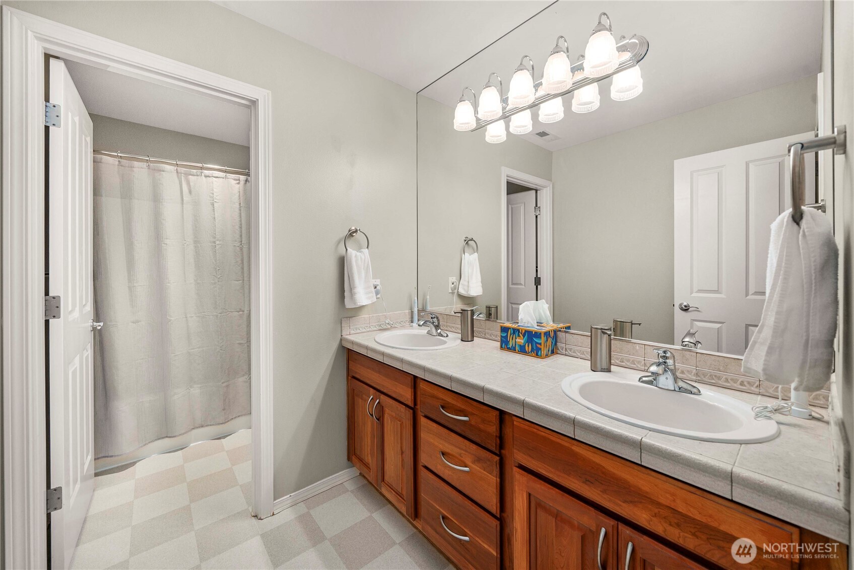 3723 Lincoln Court Northeast Renton, WA 98056 - Photo 23 of 37 a bathroom with double vanity sinks a vanity a lamp and a mirror